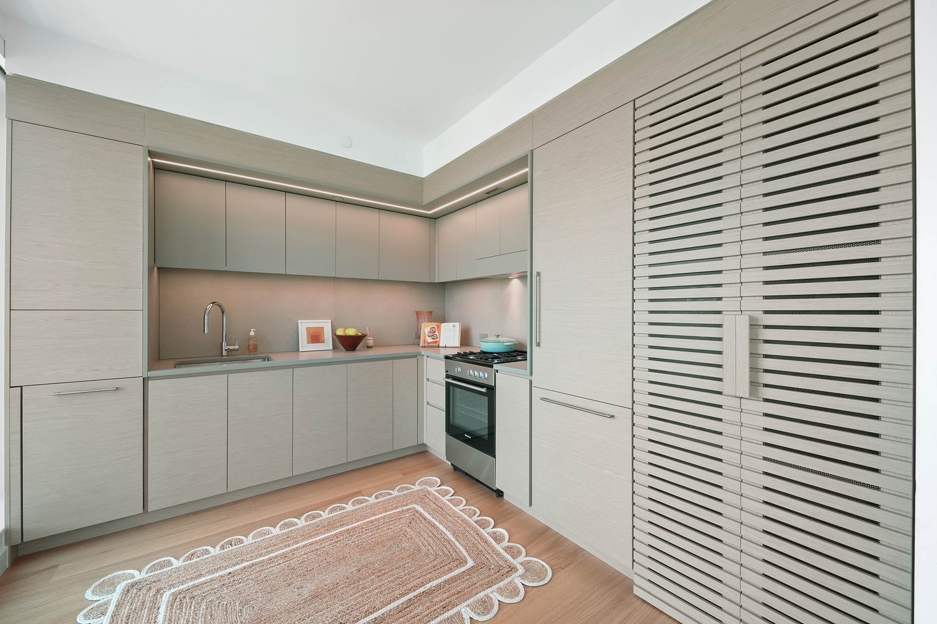 Modern kitchen with elegant grey cabinets and warm wooden flooring