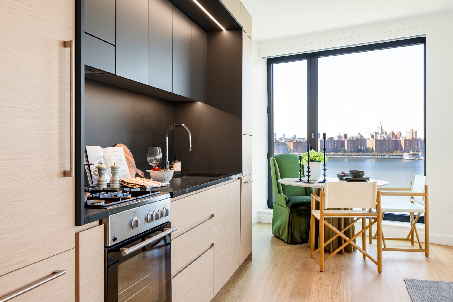 City view from a stylish kitchen with a table and chairs